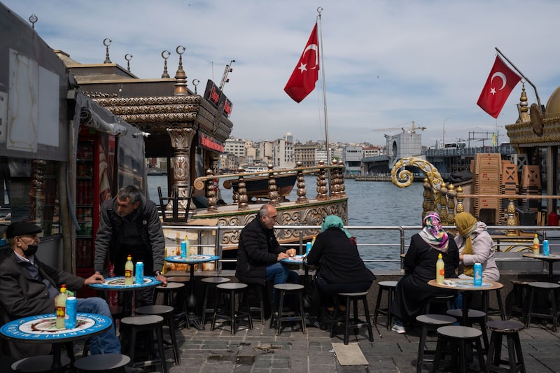 Diners at a terrace outside a port-side cafe in Istanbul, Turkey. Diners at a terrace outside a port-side cafe in Istanbul, Turkey.