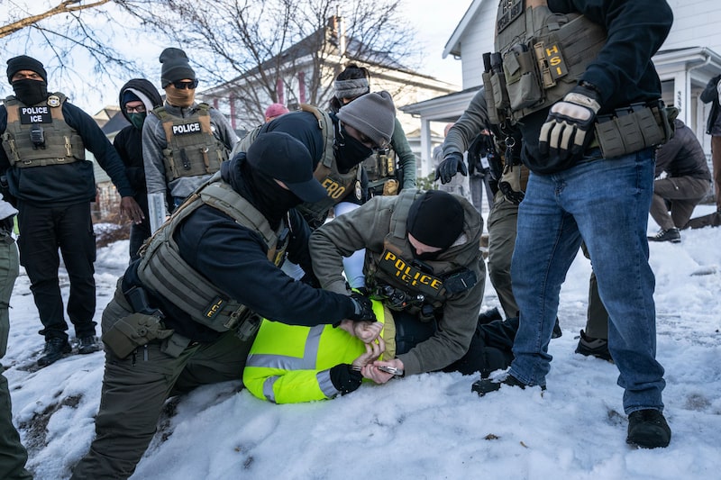 Federal law enforcement agents detain a demonstrator during a raid in south Minneapolis on Jan. 13. Federal law enforcement agents detain a demonstrator during a raid in south Minneapolis on Jan. 13.