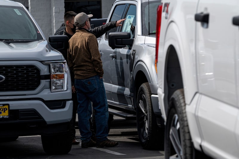A customer and salesman look at a vehicle for sale at a Ford dealership in Richmond, California, US, on Tuesday, Feb. 21, 2023. The average price for a new vehicle in the US has jumped to almost $50,000, up 30% since 2019, according to JPMorgan. A customer and salesman look at a vehicle for sale at a Ford dealership in Richmond, California, US, on Tuesday, Feb. 21, 2023. The average price for a new vehicle in the US has jumped to almost $50,000, up 30% since 2019, according to JPMorgan.