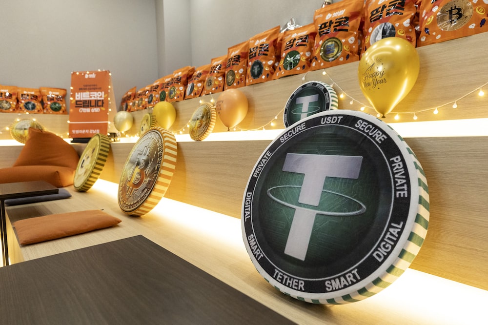 The Tether (USDT) logo on a cushion displayed at a Bithumb exchange office in Seoul, South Korea, on Friday, Feb. 6, 2026. Cryptocurrencies have been on shaky ground ever since a brutal series of liquidations in October that sapped market confidence. Photographer: Jean Chung/Bloomberg The Tether (USDT) logo on a cushion displayed at a Bithumb exchange office in Seoul, South Korea, on Friday, Feb. 6, 2026. Cryptocurrencies have been on shaky ground ever since a brutal series of liquidations in October that sapped market confidence. Photographer: Jean Chung/Bloomberg