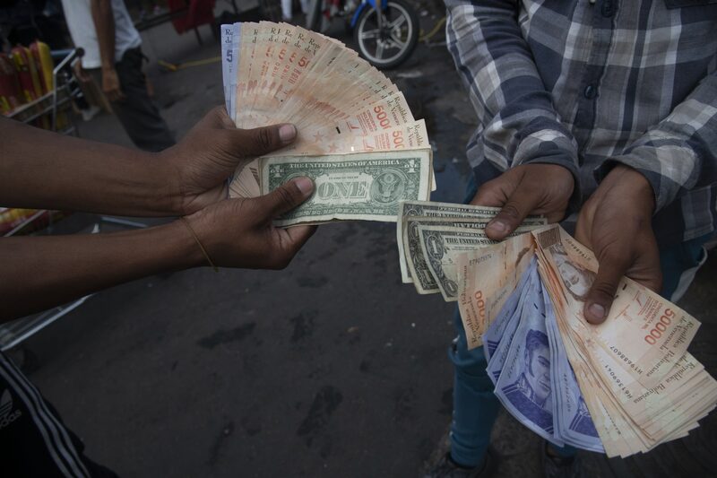 Billetes de dólares estadounidenses y bolívares en el barrio de Catia de Caracas, Venezuela, el jueves 25 de marzo de 2021. Billetes de dólares estadounidenses y bolívares en el barrio de Catia de Caracas, Venezuela, el jueves 25 de marzo de 2021.