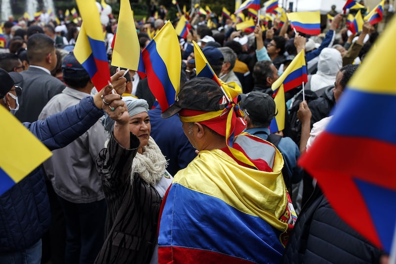 Demonstrators hold Colombia flags during a pro-government march to Bolivar Square in Bogota, Colombia, on Tuesday, Feb. 14, 2023. President Gustavo Petros plans to overhaul the Colombian welfare state are facing their first big test as his supporters take to the streets to pressure lawmakers debating his controversial health care bill. Photographer: Ivan Valencia/Bloomberg Demonstrators hold Colombia flags during a pro-government march to Bolivar Square in Bogota, Colombia, on Tuesday, Feb. 14, 2023. President Gustavo Petros plans to overhaul the Colombian welfare state are facing their first big test as his supporters take to the streets to pressure lawmakers debating his controversial health care bill. Photographer: Ivan Valencia/Bloomberg