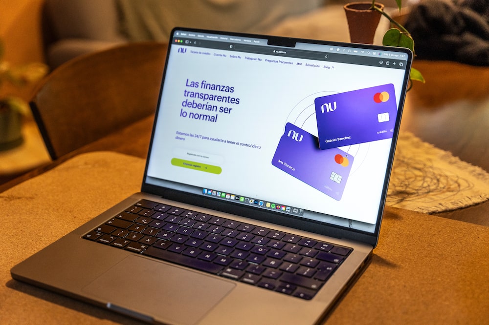 The Nubank website on a laptop arranged in Mexico City, Mexico, on Saturday, Aug. 5, 2023. Nu Holdings Ltd., the Brazilian digital bank that counts Warren Buffett's Berkshire Hathaway Inc. among its biggest stockholders, is betting big that its high-yield savings accounts will stoke growth in Latin America's second-largest economy. Photographer: Alejandro Cegarra/Bloomberg The Nubank website on a laptop arranged in Mexico City, Mexico, on Saturday, Aug. 5, 2023. Nu Holdings Ltd., the Brazilian digital bank that counts Warren Buffett's Berkshire Hathaway Inc. among its biggest stockholders, is betting big that its high-yield savings accounts will stoke growth in Latin America's second-largest economy. Photographer: Alejandro Cegarra/Bloomberg