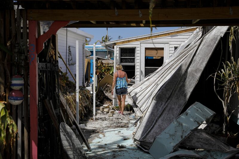 A resident walks inside her damaged house following Hurricane Ian in Matlacha, Florida, US, on Wednesday, Oct. 5, 2022. President Biden and Governor DeSantis have feuded over political issues, including migrants, but are coordinating on assistance for Floridians hit by a hurricane Biden's called "among the worst in the nation's history." A resident walks inside her damaged house following Hurricane Ian in Matlacha, Florida, US, on Wednesday, Oct. 5, 2022. President Biden and Governor DeSantis have feuded over political issues, including migrants, but are coordinating on assistance for Floridians hit by a hurricane Biden's called "among the worst in the nation's history."