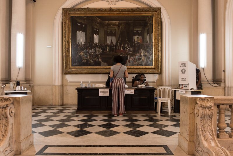 A voter provides identification to cast a ballot at a polling station during the runoff presidential election in Rio de Janeiro, Brazil, on Sunday, Oct. 30, 2022. A voter provides identification to cast a ballot at a polling station during the runoff presidential election in Rio de Janeiro, Brazil, on Sunday, Oct. 30, 2022.