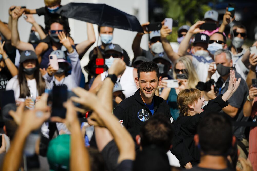 Jared Isaacman, founder of Shift4 Payments Inc. and part of the Inspiration4 civilian crew, center, ahead of the Space Exploration Technologies Corp. (SpaceX) Inspiration4 mission in Merritt Island, Florida, U.S., on Wednesday, Sept. 15, 2021. A SpaceX rocket is set to launch four civilians into orbit for a three-day voyage circling the Earth, a new milestone in Elon Musk's quest to send everyday people to the cosmos, eventually establishing a colony on Mars. Photographer: Eva Marie Uzcategui/Bloomberg Jared Isaacman, founder of Shift4 Payments Inc. and part of the Inspiration4 civilian crew, center, ahead of the Space Exploration Technologies Corp. (SpaceX) Inspiration4 mission in Merritt Island, Florida, U.S., on Wednesday, Sept. 15, 2021. A SpaceX rocket is set to launch four civilians into orbit for a three-day voyage circling the Earth, a new milestone in Elon Musk's quest to send everyday people to the cosmos, eventually establishing a colony on Mars. Photographer: Eva Marie Uzcategui/Bloomberg
