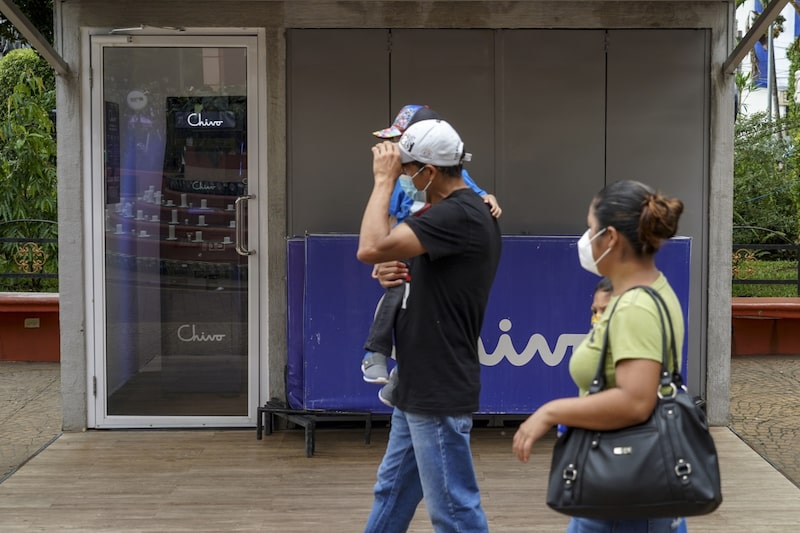 Pedestrians pass a government Chivo Bitcoin automated teller machine (ATM) kiosk on the one-year anniversary of Bitcoin adoption in Ahuachapan, El Salvador, on Wednesday, Sept. 7, 2022. Pedestrians pass a government Chivo Bitcoin automated teller machine (ATM) kiosk on the one-year anniversary of Bitcoin adoption in Ahuachapan, El Salvador, on Wednesday, Sept. 7, 2022.