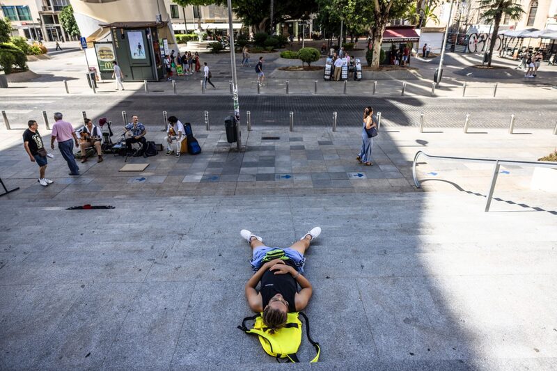 A pedestrian lays in the shade during high temperatures at La Setas in central Seville, Spain, on Thursday, July 6, 2023. A pedestrian lays in the shade during high temperatures at La Setas in central Seville, Spain, on Thursday, July 6, 2023.