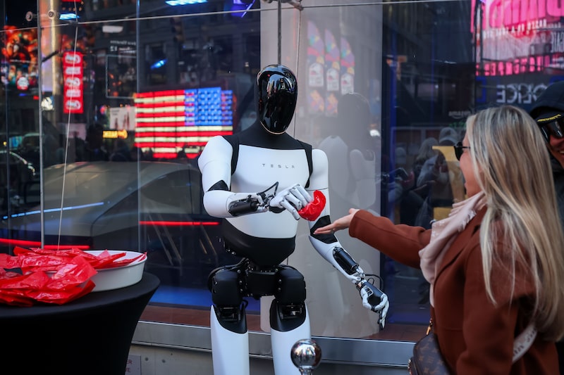 A Tesla Optimus robot hands out candy in New York last year. A Tesla Optimus robot hands out candy in New York last year.