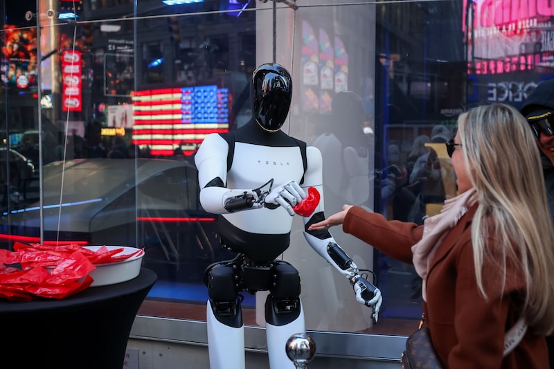 A Tesla Optimus robot hands out candy in New York last year. A Tesla Optimus robot hands out candy in New York last year.