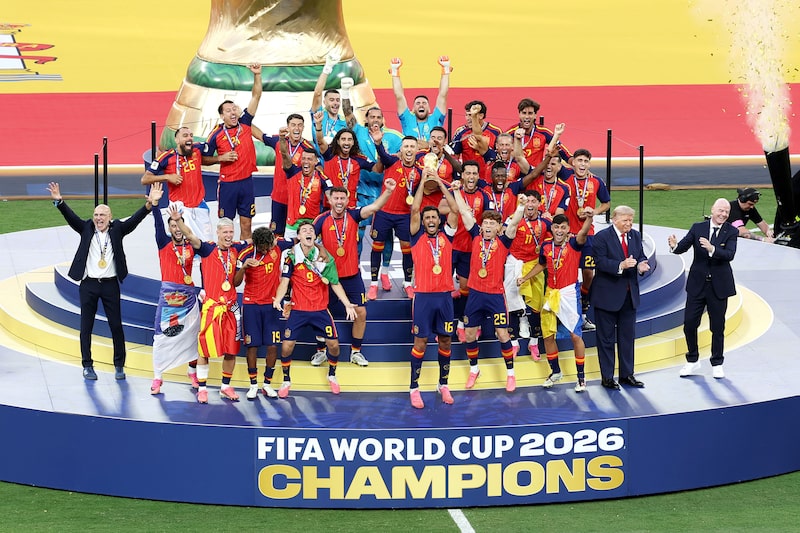 Spain lifts the World Cup trophy alongside US President Donald Trump and FIFA President Gianni Infantino. Spain lifts the World Cup trophy alongside US President Donald Trump and FIFA President Gianni Infantino.