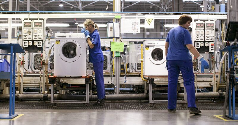Employees check washing machine units for quality control on the production line at the Electrolux AB plant in Olawa, Poland. Employees check washing machine units for quality control on the production line at the Electrolux AB plant in Olawa, Poland.