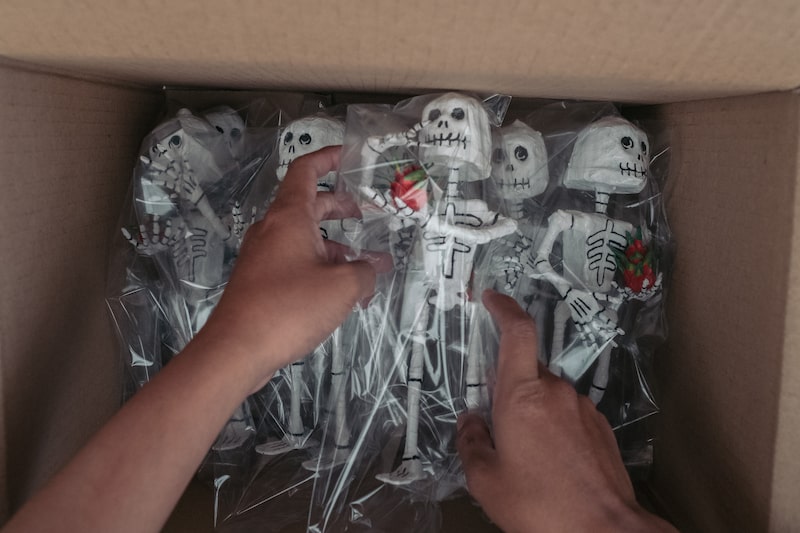 A worker places hand painted skeleton figurines into a box at a papel picado manufacturing facility in the Xochimilco neighborhood of Mexico City, Mexico on Friday, Oct.16, 2020. About two million people attended the Day of the Dead parade last year on November 2 in Mexico City. This year, Mexico City will hold virtual Day of the Dead celebrations in order to maintain traditions in the face of the coronavirus pandemic, reports Mexico News Daily. Photographer: Jeoffrey Guillemard/Bloomberg A worker places hand painted skeleton figurines into a box at a papel picado manufacturing facility in the Xochimilco neighborhood of Mexico City, Mexico on Friday, Oct.16, 2020. About two million people attended the Day of the Dead parade last year on November 2 in Mexico City. This year, Mexico City will hold virtual Day of the Dead celebrations in order to maintain traditions in the face of the coronavirus pandemic, reports Mexico News Daily. Photographer: Jeoffrey Guillemard/Bloomberg