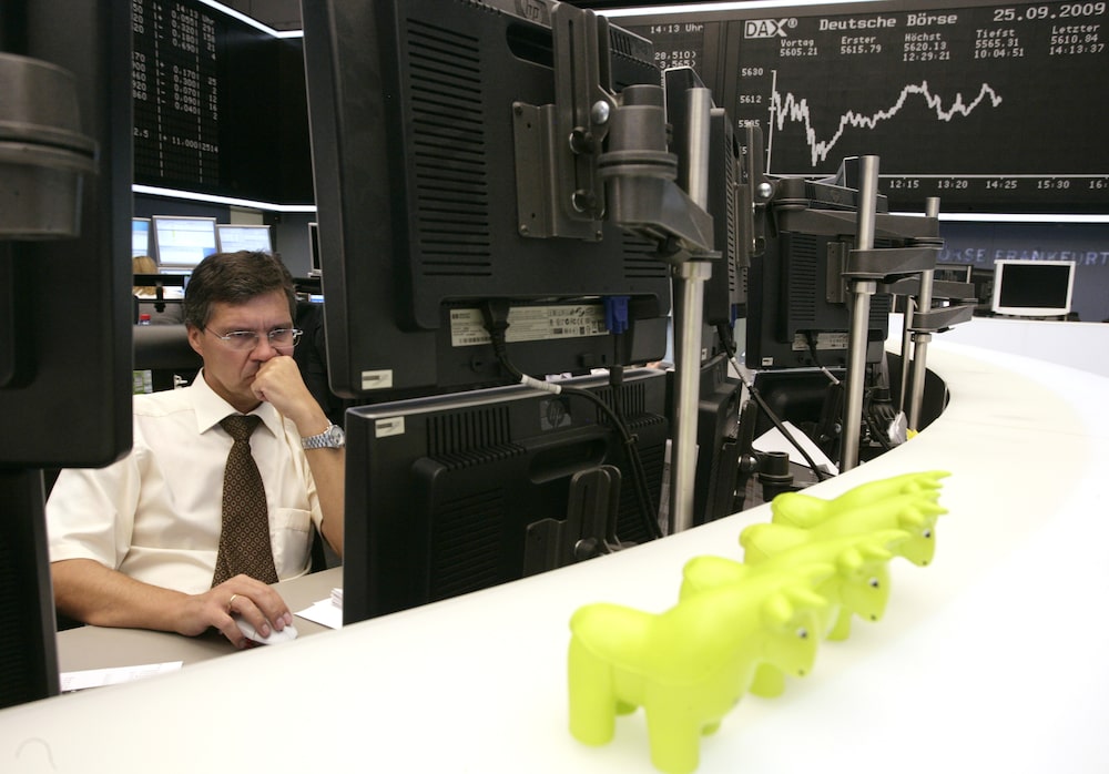 A trader, with toy bulls on his desk, works at the Frankfurt stock exchange, in Frankfurt, Germany, on Friday, Sept. 25, 2009. German stocks fell, erasing earlier advances, after orders for durable goods in the U.S. unexpectedly slumped in August. Photographer: Ralph Orlowski/Bloomberg A trader, with toy bulls on his desk, works at the Frankfurt stock exchange, in Frankfurt, Germany, on Friday, Sept. 25, 2009. German stocks fell, erasing earlier advances, after orders for durable goods in the U.S. unexpectedly slumped in August. Photographer: Ralph Orlowski/Bloomberg