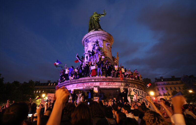 Participants wave French national tricolors during an election night rally following the first results of the second round of France's legislative election at Place de la Republique in Paris on July 7, 2024. A loose alliance of French left-wing parties thrown together for snap elections was on course to become the biggest parliamentary bloc and beat the far right, according to shock projected results. (Photo by Emmanuel Dunand / AFP) (Photo by EMMANUEL DUNAND/AFP via Getty Images) Participants wave French national tricolors during an election night rally following the first results of the second round of France's legislative election at Place de la Republique in Paris on July 7, 2024. A loose alliance of French left-wing parties thrown together for snap elections was on course to become the biggest parliamentary bloc and beat the far right, according to shock projected results. (Photo by Emmanuel Dunand / AFP) (Photo by EMMANUEL DUNAND/AFP via Getty Images)