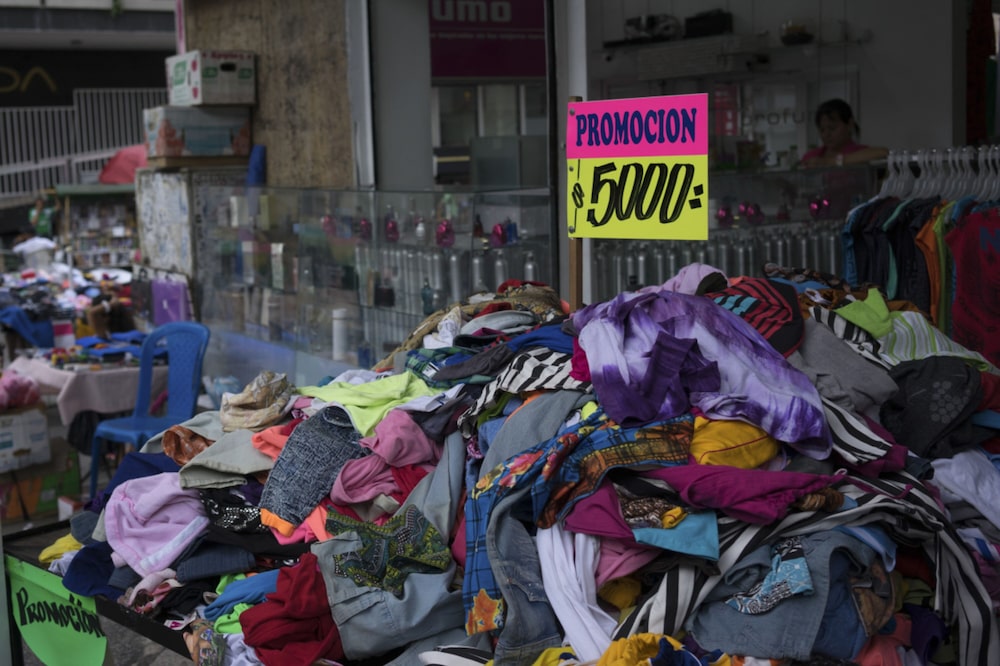 Un cartel anuncia el precio de la ropa a la venta por un vendedor ambulante en Cali, Colombia, el miércoles 12 de agosto de 2015. Un cartel anuncia el precio de la ropa a la venta por un vendedor ambulante en Cali, Colombia, el miércoles 12 de agosto de 2015.