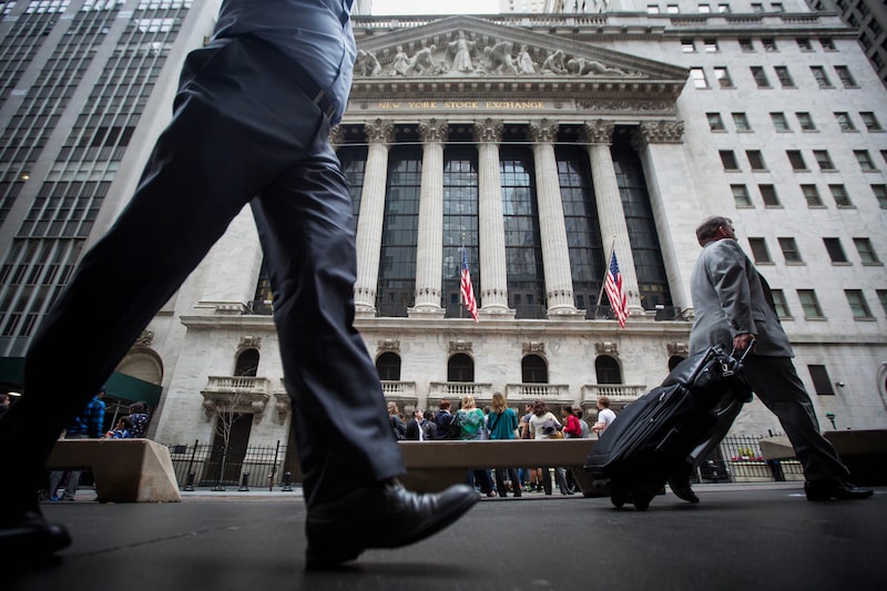 Pedestrians walk past the New York Stock Exchange (NYSE) stands in New York, U.S., on Friday, April 1, 2016. U.S. stock-index futures fell, tracking declines in crude oil, amid data showing job gains and higher wages that supported the case for raising interest rates. Photographer: Michael Nagle/Bloomberg Pedestrians walk past the New York Stock Exchange (NYSE) stands in New York, U.S., on Friday, April 1, 2016. U.S. stock-index futures fell, tracking declines in crude oil, amid data showing job gains and higher wages that supported the case for raising interest rates. Photographer: Michael Nagle/Bloomberg