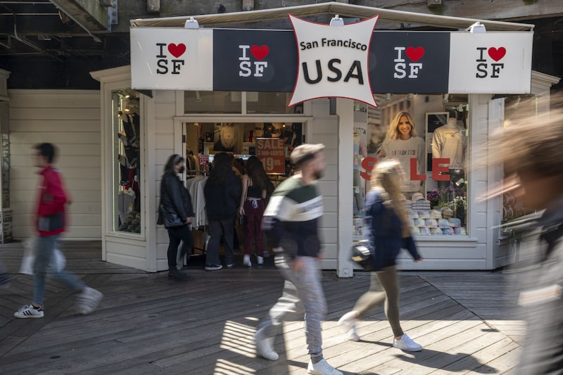 Tourists walk on Pier 39 in San Francisco, California. Tourists walk on Pier 39 in San Francisco, California.