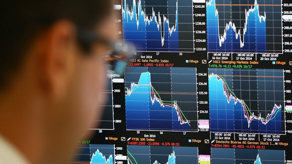 LONDON, ENGLAND - OCTOBER 20: An employee views trading screens at the offices of Panmure Gordon and Co on October 20, 2014 in London, England. Markets stabilised over the weekend following global turbulence amid fears over the Ebola virus and global economic concerns. (Photo by Carl Court/Getty Images) LONDON, ENGLAND - OCTOBER 20: An employee views trading screens at the offices of Panmure Gordon and Co on October 20, 2014 in London, England. Markets stabilised over the weekend following global turbulence amid fears over the Ebola virus and global economic concerns. (Photo by Carl Court/Getty Images)