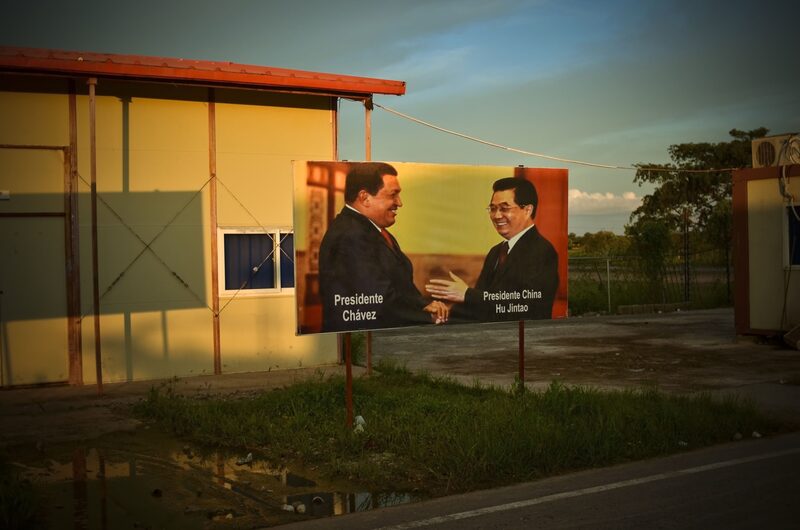 A sign featuring then-Presidents Chavez and Hu Jintao at the Tinaco-Anaco railway construction site in 2012. A sign featuring then-Presidents Chavez and Hu Jintao at the Tinaco-Anaco railway construction site in 2012.