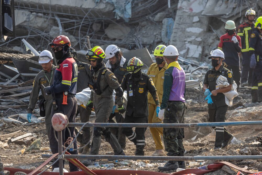 Rescue workers extract the body of a construction worker from the rubble of a building that collapsed following an earthquake in Bangkok, Thailand, Saturday, March 29, 2025. Rescuers are still searching for dozens of people missing from the site of the high-rise building, which was under construction when it collapsed after a 7.7-magnitude earthquake struck neighboring Myanmar. Photographer: Andre Malerba/Bloomberg Rescue workers extract the body of a construction worker from the rubble of a building that collapsed following an earthquake in Bangkok, Thailand, Saturday, March 29, 2025. Rescuers are still searching for dozens of people missing from the site of the high-rise building, which was under construction when it collapsed after a 7.7-magnitude earthquake struck neighboring Myanmar. Photographer: Andre Malerba/Bloomberg