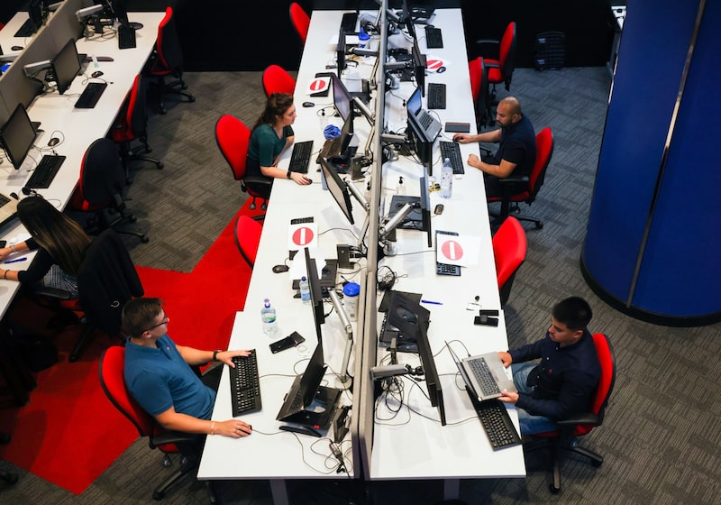 Employees work at their desks in the offices of a branch of Metro Bank Plc in London, U.K., on Thursday, Aug. 26, 2021. Some two dozen Metro Bank office staff got an early taste of what hybrid working will look like this week as they trialled their firm's new approach to office life. Photographer: Chris Ratcliffe/Bloomberg Employees work at their desks in the offices of a branch of Metro Bank Plc in London, U.K., on Thursday, Aug. 26, 2021. Some two dozen Metro Bank office staff got an early taste of what hybrid working will look like this week as they trialled their firm's new approach to office life. Photographer: Chris Ratcliffe/Bloomberg