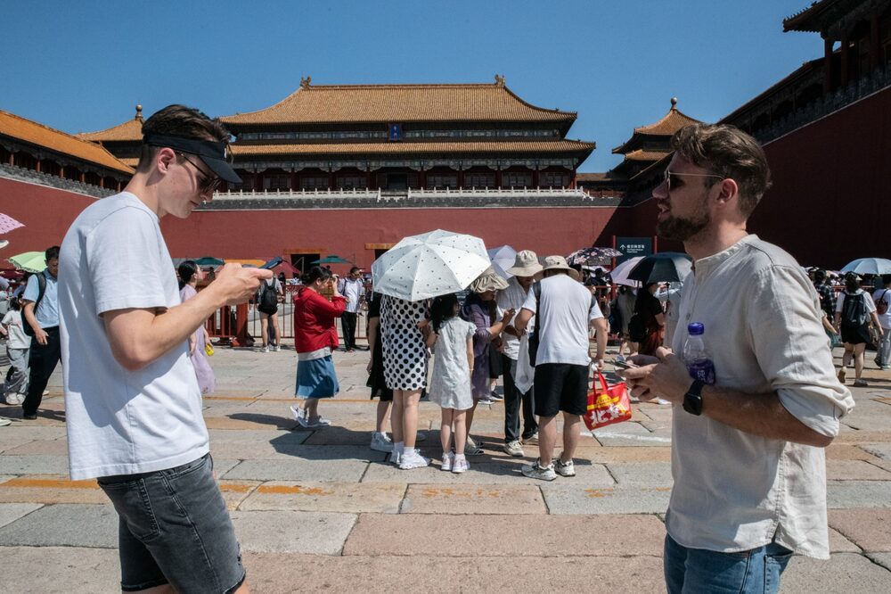 Two German tourists try to get tickets online prior to entering the Palace Museum at the Forbidden City. Two German tourists try to get tickets online prior to entering the Palace Museum at the Forbidden City.