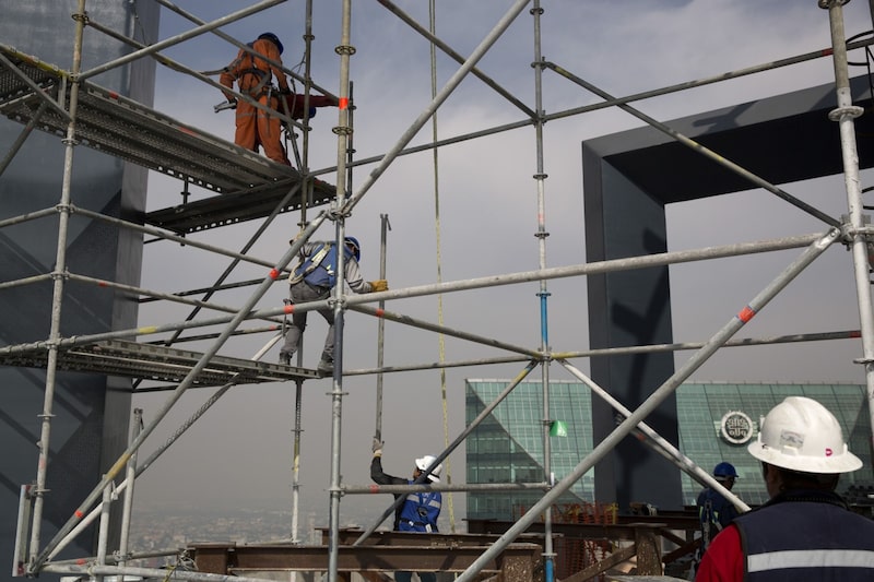 A group of workers disassemble scaffolding on the 50th floor during construction of the BBVA Bancomer office tower in Mexico City, Mexico, on Wednesday, Dec. 10, 2014. Mexico created 122,850 jobs in November, according to a report by the Mexican Social Security Institute. Photographer: Susana Gonzalez/Bloomberg A group of workers disassemble scaffolding on the 50th floor during construction of the BBVA Bancomer office tower in Mexico City, Mexico, on Wednesday, Dec. 10, 2014. Mexico created 122,850 jobs in November, according to a report by the Mexican Social Security Institute. Photographer: Susana Gonzalez/Bloomberg