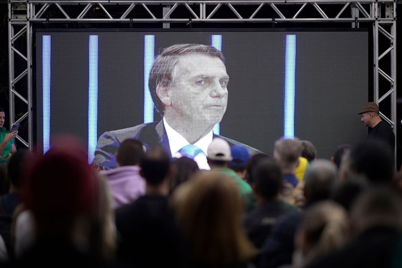 People watch Jair Bolsonaro's interview on a big screen in Minas Gerais State on Aug. 22. People watch Jair Bolsonaro's interview on a big screen in Minas Gerais State on Aug. 22.