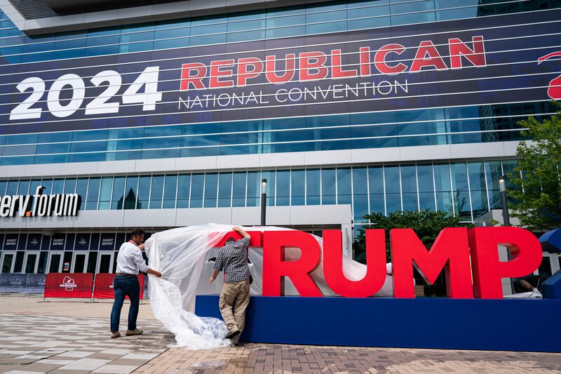 Workers remove plastic covering from signage ahead of the Republican National Convention (RNC) in Milwaukee, Wisconsin, US, on Sunday, July 14, 2024. Former President Donald Trump confirmed that he will be attending the Republican National Convention next week, hours after he was shot at a campaign rally in Pennsylvania. Photographer: Al Drago/Bloomberg Workers remove plastic covering from signage ahead of the Republican National Convention (RNC) in Milwaukee, Wisconsin, US, on Sunday, July 14, 2024. Former President Donald Trump confirmed that he will be attending the Republican National Convention next week, hours after he was shot at a campaign rally in Pennsylvania. Photographer: Al Drago/Bloomberg