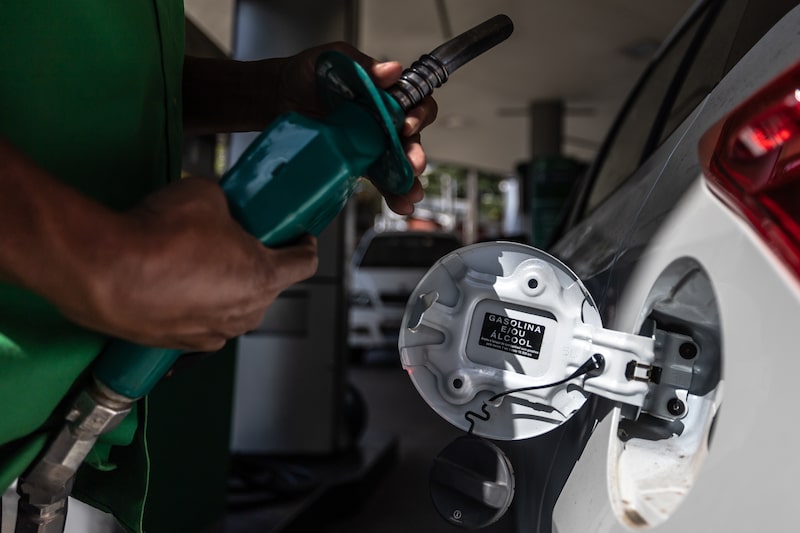 A worker refuels a vehicle at a gas station in Sao Paulo, Brazil. A worker refuels a vehicle at a gas station in Sao Paulo, Brazil.