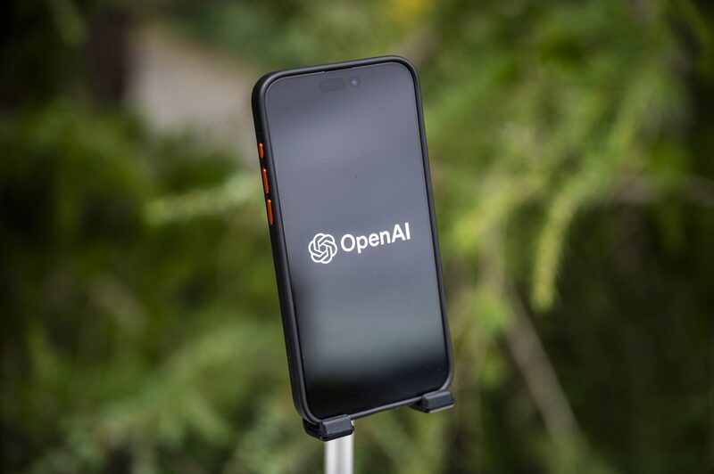 The Open AI logo on a smartphone arranged in Crockett, California, US, on Friday, Dec. 29, 2023. Microsoft has invested some $13 billion in OpenAI and integrated its products into its core businesses, quickly becoming the undisputed leader of AI among big tech firms. The Open AI logo on a smartphone arranged in Crockett, California, US, on Friday, Dec. 29, 2023. Microsoft has invested some $13 billion in OpenAI and integrated its products into its core businesses, quickly becoming the undisputed leader of AI among big tech firms.