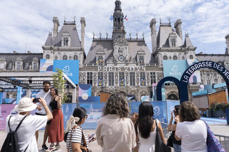 Visitors in the Hotel de Ville fan zone ahead of the Olympic Games in central Paris, France, on Thursday, July 25, 2024. French residents have been postponing holidays until after the Olympics, while international customers are staying away. Photographer: Nathan Laine/Bloomberg Visitors in the Hotel de Ville fan zone ahead of the Olympic Games in central Paris, France, on Thursday, July 25, 2024. French residents have been postponing holidays until after the Olympics, while international customers are staying away. Photographer: Nathan Laine/Bloomberg