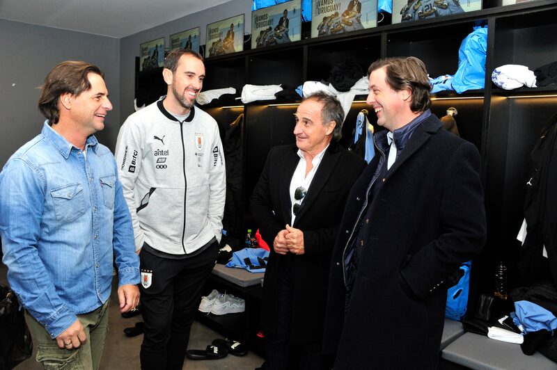 El presidente de Uruguay Luis Lacalle Pou en un vestuario del Estado Centenario junto al futbolista Diego Godín, el profesor Óscar Ortega y el presidente de la Asociación Uruguay de Fútbol, Ignacio Alonso. Lacalle Pou entregó ese día, 11 de junio, el pabellón a la delegación que viajará a Catar 2022. Fotografía: Presidencia de la República. El presidente de Uruguay Luis Lacalle Pou en un vestuario del Estado Centenario junto al futbolista Diego Godín, el profesor Óscar Ortega y el presidente de la Asociación Uruguay de Fútbol, Ignacio Alonso. Lacalle Pou entregó ese día, 11 de junio, el pabellón a la delegación que viajará a Catar 2022. Fotografía: Presidencia de la República.