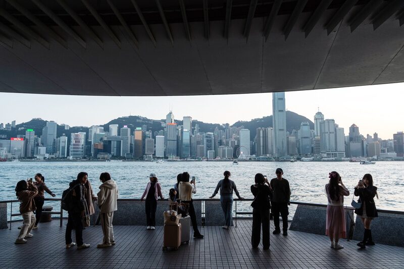 Tourists along the Tsim Sha Tsui promenade during the Lunar New Year holiday in Hong Kong, China, on Monday, Feb. 12, 2024. Hong Kong's economy grew 3.2% last year, slower than expected and down from an earlier official projection of as much as 5%. Photographer: Chan Long Hei/Bloomberg Tourists along the Tsim Sha Tsui promenade during the Lunar New Year holiday in Hong Kong, China, on Monday, Feb. 12, 2024. Hong Kong's economy grew 3.2% last year, slower than expected and down from an earlier official projection of as much as 5%. Photographer: Chan Long Hei/Bloomberg