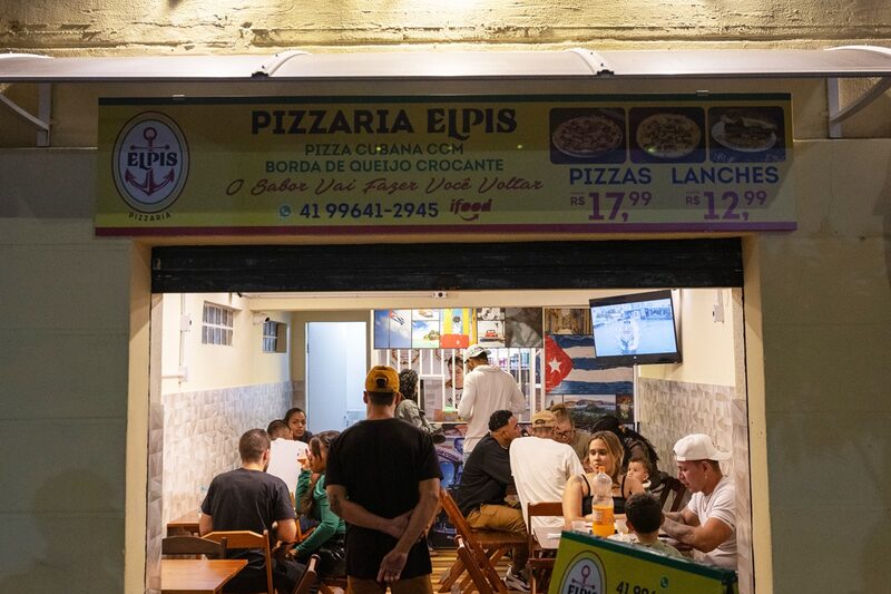 Cubans file into de Posada's pizza restaurant.tes, in Curitiba, Brazil, on Sunday, May 25, 2025. Photographer: Maira Erlich/Bloomberg Cubans file into de Posada's pizza restaurant.tes, in Curitiba, Brazil, on Sunday, May 25, 2025. Photographer: Maira Erlich/Bloomberg