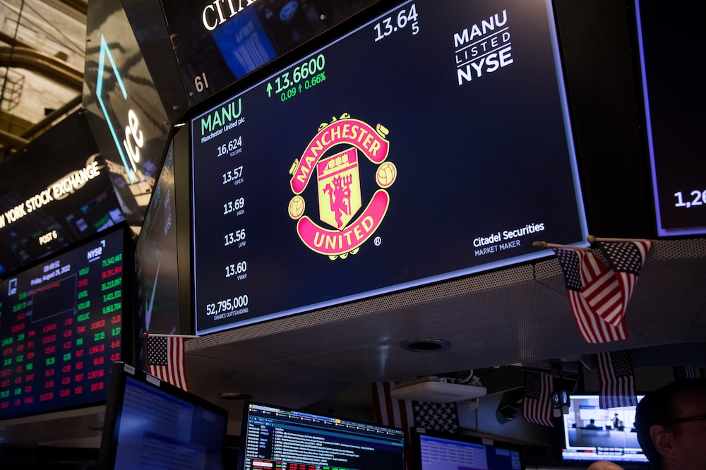 Manchester United signage on a monitor on the floor of the New York Stock Exchange (NYSE) in New York, US, on Friday, Aug. 26, 2022. Stocks sank as Jerome Powell gave a short and clear message that rates will stay high for some time, pushing back against the idea of a Federal Reserve pivot that could complicate its war against inflation. Photographer: Michael Nagle/Bloomberg Manchester United signage on a monitor on the floor of the New York Stock Exchange (NYSE) in New York, US, on Friday, Aug. 26, 2022. Stocks sank as Jerome Powell gave a short and clear message that rates will stay high for some time, pushing back against the idea of a Federal Reserve pivot that could complicate its war against inflation. Photographer: Michael Nagle/Bloomberg
