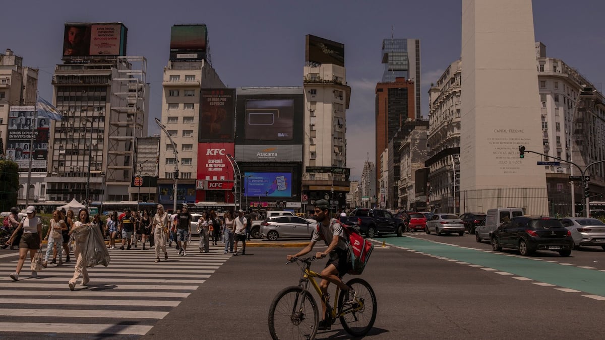 Pedestrians and traffic near the Obelisk on 9 de Julio Avenue in Buenos Aires.