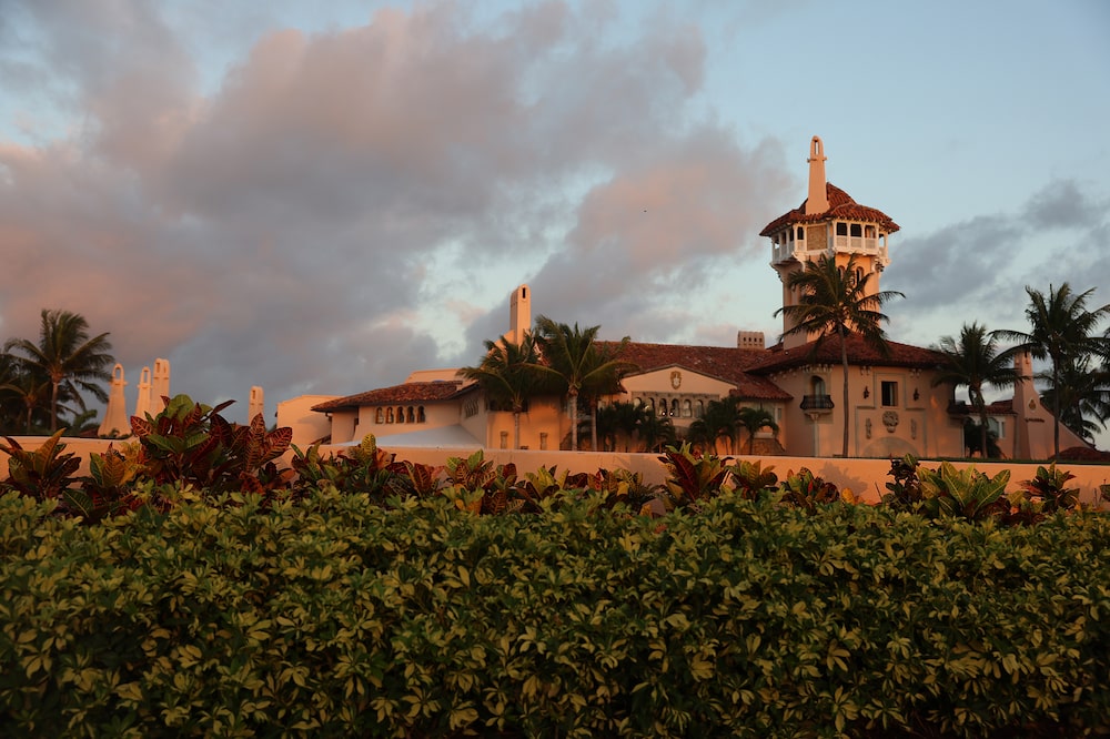 PALM BEACH, FLORIDA - MARCH 22: The exterior of former President Donald Trump's Mar-a-Lago home is seen on March 22, 2023 in Palm Beach, Florida. Trump said on a social media post that he expects to be arrested in connection with an investigation into a hush-money scheme involving adult film actress Stormy Daniels and called on his supporters to protest any such move. Trump awaits a possible indictment from the Manhattan grand jury probing the hush money scheme. (Photo by Joe Raedle/Getty Images) PALM BEACH, FLORIDA - MARCH 22: The exterior of former President Donald Trump's Mar-a-Lago home is seen on March 22, 2023 in Palm Beach, Florida. Trump said on a social media post that he expects to be arrested in connection with an investigation into a hush-money scheme involving adult film actress Stormy Daniels and called on his supporters to protest any such move. Trump awaits a possible indictment from the Manhattan grand jury probing the hush money scheme. (Photo by Joe Raedle/Getty Images)