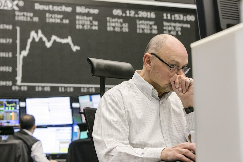A trader sits at his desk and monitors financial data as the movements of the DAX Index curve are displayed on a screen inside the Frankfurt Stock Exchange in Frankfurt, Germany, on Monday, Dec. 5, 2016. The euro declined with Asian stocks and Italys bonds amid concern that nations vote against constitutional reform will embolden nationalist movements. Photographer: Martin Leissl /Bloomberg A trader sits at his desk and monitors financial data as the movements of the DAX Index curve are displayed on a screen inside the Frankfurt Stock Exchange in Frankfurt, Germany, on Monday, Dec. 5, 2016. The euro declined with Asian stocks and Italys bonds amid concern that nations vote against constitutional reform will embolden nationalist movements. Photographer: Martin Leissl /Bloomberg