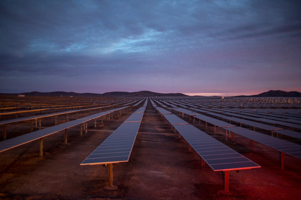 Photovoltaics panels at sunset in Cerro Dominador thermal project area. Sierra Gorda, Atacama. Chile. The Cerro Dominador solar complex will consist of a photovoltaic plant with a capacity of 100 MW and the first thermosolar plant in Latin America, with 110 MW of capacity and 17.5 hours of thermal storage. Together, the complex's solar field reaches 1,000 hectares. August 1st, 2018. Photographer: Cristóbal Olivares. Photovoltaics panels at sunset in Cerro Dominador thermal project area. Sierra Gorda, Atacama. Chile. The Cerro Dominador solar complex will consist of a photovoltaic plant with a capacity of 100 MW and the first thermosolar plant in Latin America, with 110 MW of capacity and 17.5 hours of thermal storage. Together, the complex's solar field reaches 1,000 hectares. August 1st, 2018. Photographer: Cristóbal Olivares.