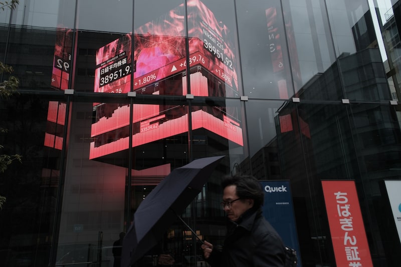An electronic stock board displayed inside the Kabuto One building in Tokyo, Japan, on Thursday, Feb. 22, 2024. Japanese stocks reclaimed a historic peak reached more than three decades ago as investors pour money into a country that's finally escaped deflation and is on a path to sustainable growth. Photographer: Soichiro Koriyama/Bloomberg An electronic stock board displayed inside the Kabuto One building in Tokyo, Japan, on Thursday, Feb. 22, 2024. Japanese stocks reclaimed a historic peak reached more than three decades ago as investors pour money into a country that's finally escaped deflation and is on a path to sustainable growth. Photographer: Soichiro Koriyama/Bloomberg