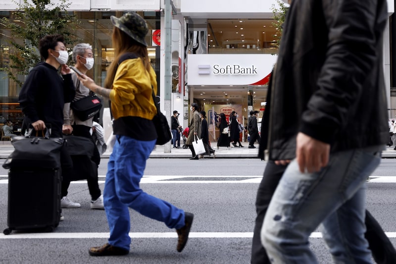 Pedestrians in front of a SoftBank Corp. store in Tokyo, Japan, on Sunday, Nov. 7, 2021. Pedestrians in front of a SoftBank Corp. store in Tokyo, Japan, on Sunday, Nov. 7, 2021.