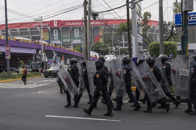 Police officers stand guard in the area around the Mexico City Stadium, known locally as Azteca Stadium, on June 9. Police officers stand guard in the area around the Mexico City Stadium, known locally as Azteca Stadium, on June 9.