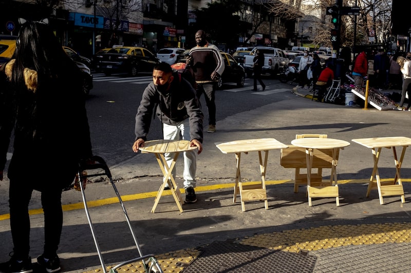 A street vendor sells tables on Corrientes Avenue in the Balvanera neighborhood of Buenos Aires, Argentina. A street vendor sells tables on Corrientes Avenue in the Balvanera neighborhood of Buenos Aires, Argentina.