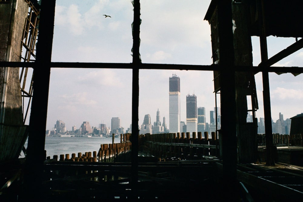 The growing Twin Towers, seen from an abandoned pier in New Jersey, 1970. The growing Twin Towers, seen from an abandoned pier in New Jersey, 1970.