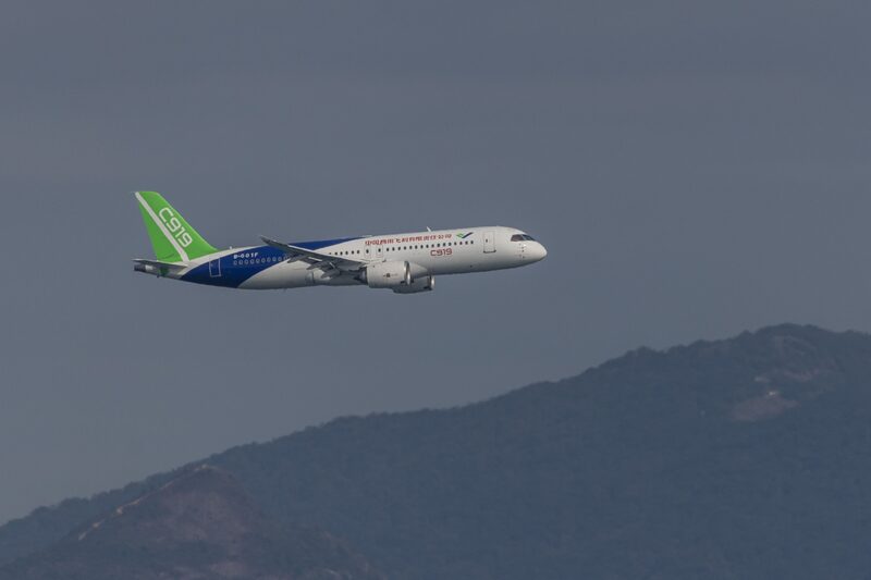 A Commercial Aircraft Corp of China Ltd. (Comac) C919 aircraft flies in Hong Kong, China, on Saturday, Dec. 16, 2023. China displayed its aircraft-manufacturing credentials by conducting a flyby of Hong Kongs Victoria Harbour with a domestically made passenger plane designed to take on Airbus SE and Boeing Co. narrowbodies. Photographer: Paul Yeung/Bloomberg A Commercial Aircraft Corp of China Ltd. (Comac) C919 aircraft flies in Hong Kong, China, on Saturday, Dec. 16, 2023. China displayed its aircraft-manufacturing credentials by conducting a flyby of Hong Kongs Victoria Harbour with a domestically made passenger plane designed to take on Airbus SE and Boeing Co. narrowbodies. Photographer: Paul Yeung/Bloomberg