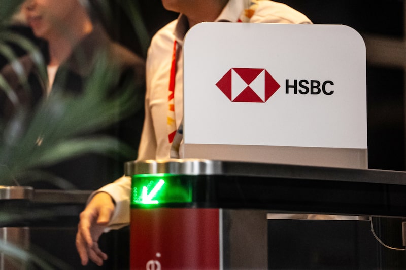 Signage at the HSBC Holdings Plc headquarters building in Hong Kong. Signage at the HSBC Holdings Plc headquarters building in Hong Kong.