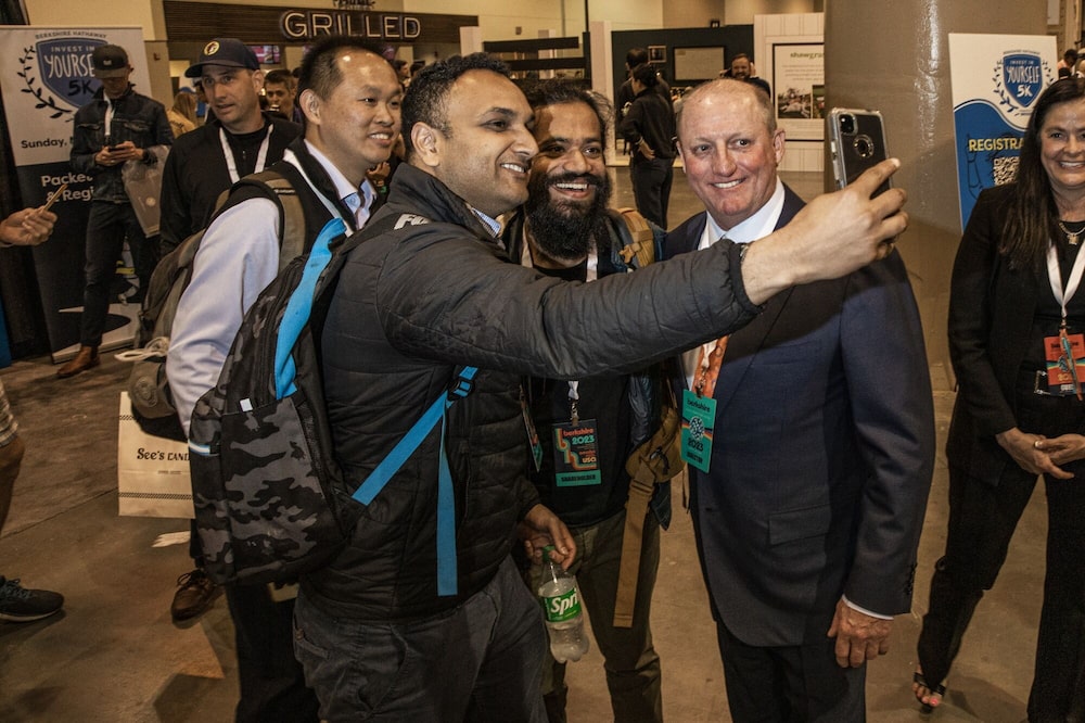 Greg Abel, right, takes a selfie photograph with attendees during the Berkshire Hathaway annual shareholder meeting in 2023. Greg Abel, right, takes a selfie photograph with attendees during the Berkshire Hathaway annual shareholder meeting in 2023.