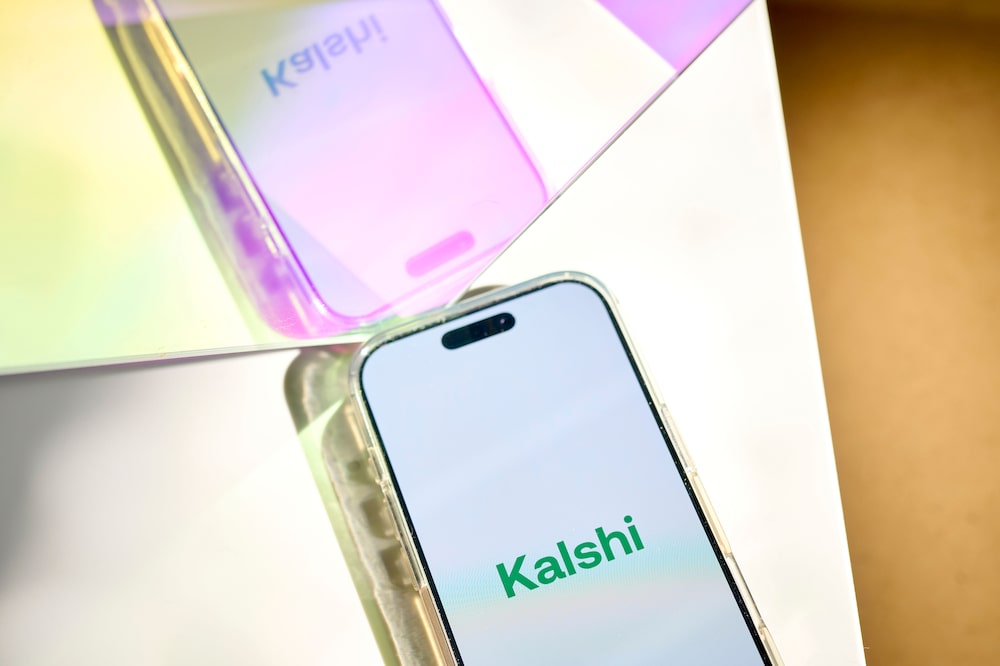 The Kalshi logo arranged on a smartphone in New York, US, on Monday, Feb. 10, 2025. The Commodity Futures Trading Commission is asking Crypto.com and Kalshi Inc. to explain how their recently launched Super Bowl event contracts comply with derivatives regulations. Photographer: Gabby Jones/Bloomberg The Kalshi logo arranged on a smartphone in New York, US, on Monday, Feb. 10, 2025. The Commodity Futures Trading Commission is asking Crypto.com and Kalshi Inc. to explain how their recently launched Super Bowl event contracts comply with derivatives regulations. Photographer: Gabby Jones/Bloomberg